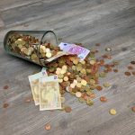 cash falling down on floor in a glass