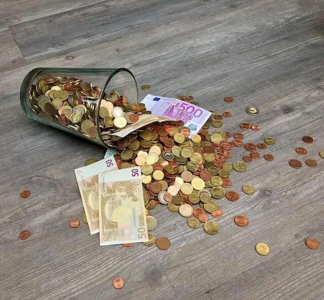 cash falling down on floor in a glass