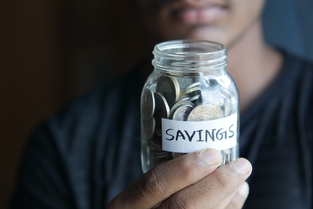 person showing jar with savings