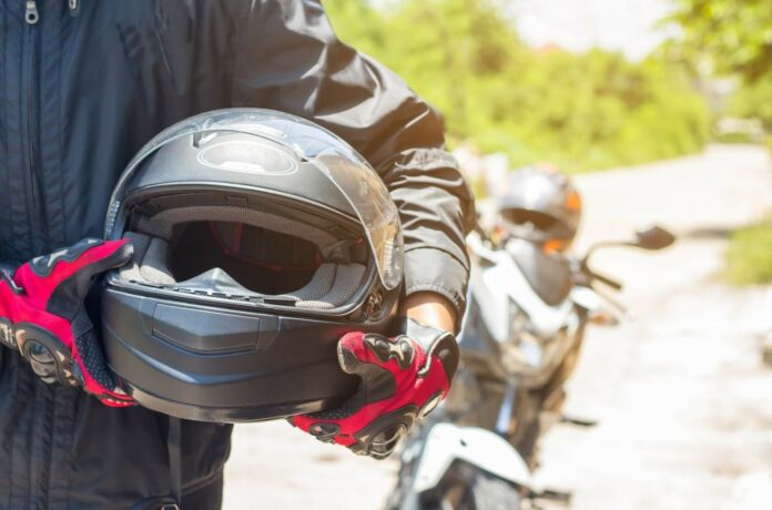 Man holding motorcycle helmet