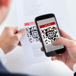 Professional male hand scanning QR code
