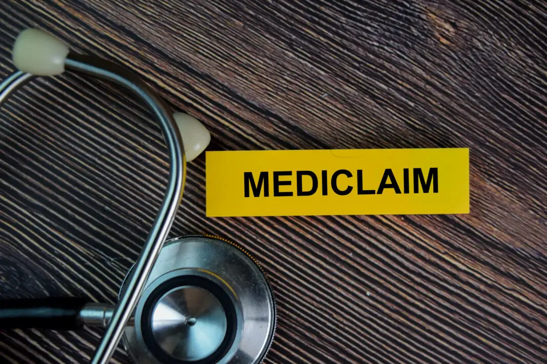 a sticky note on a table saying mediclaim