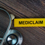 a sticky note on a table saying mediclaim